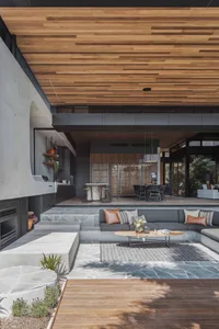 A modern industrial living space featuring concrete and wood materials.