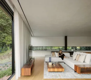 Modern living room featuring minimalist design with wood finishes and a neutral color palette.
