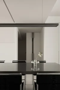 Modern minimalist dining room featuring metallic table and chairs.