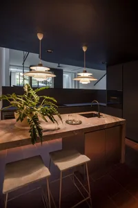 A modern residential kitchen featuring a marble counter.