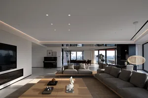 Modern residential living room featuring concrete, glass, leather, and wood finishes.