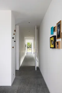 A modern corridor featuring a concrete floor and minimalist decor.