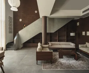 Modern living room featuring concrete walls and wooden furniture.