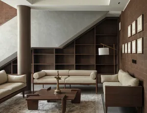 A modern living room with wooden furniture and a large bookshelf.