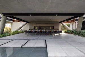A modern patio featuring concrete furniture and a sleek design.
