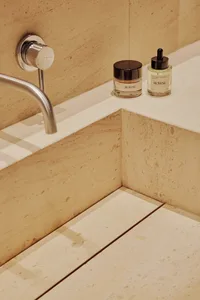 Minimalist bathroom with stone counter and minimalist decor.