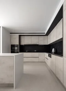 Modern kitchen featuring black marble countertops and concrete cabinets