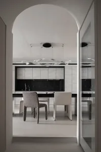 A contemporary kitchen featuring minimalist design with concrete and glass materials.