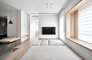 Minimalist living room with a contemporary design, featuring wooden elements and a sleek, uncluttered layout.