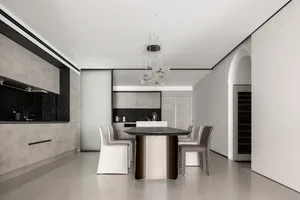 Modern residential dining room with minimalist design and concrete finishes