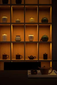 Traditional tea ceremony setting featuring clay jars and shelves.