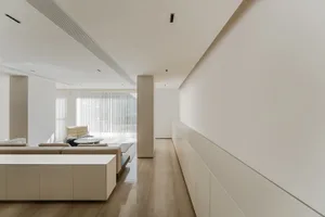 A minimalist interior design featuring concrete walls and flooring.