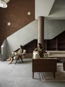 People sitting in a modern living room with neutral tones and minimalist furniture