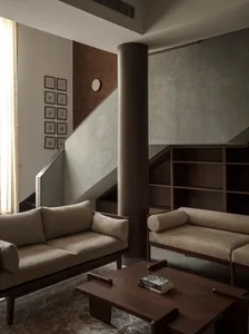 Contemporary living room with minimalist furniture and wooden accents.