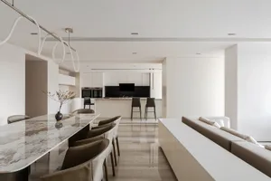 Modern residential kitchen featuring a marble countertop and white cabinetry.