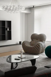 Contemporary modern living room with a cotton-cushioned sofa, wooden floor, and black and white patterned cushion