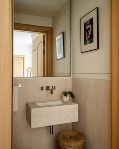 Minimalist bathroom with concrete walls and a white rectangular sink.