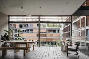 Large modern living area with minimalist design, warm wooden floors, and ample natural light.