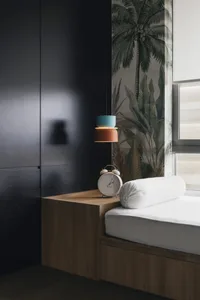 A minimalist bedroom showcasing a modern design with wooden accents.