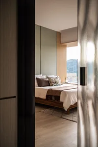 Modern bedroom featuring wooden furniture and fabric bedding