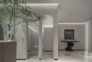A minimalist interior space featuring concrete and glass elements.