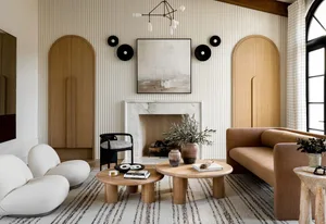 A minimalist living room featuring a marble fireplace, wooden tables, and a woolen rug.