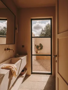 Interior design featuring a contemporary bathroom with concrete elements and natural light.