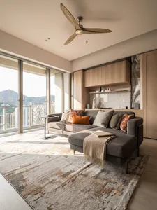 Modern living room featuring a gray sectional sofa, wooden floors, and a large window overlooking the city.