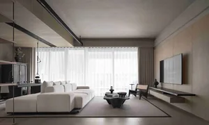 Modern minimalist living room with a white sectional couch, fabric cushions, and large windows.