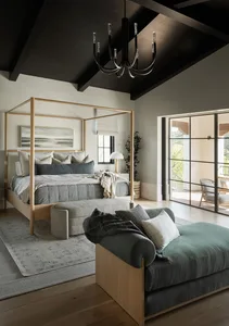 Modern bedroom interior with a wooden four-poster bed, white and gray bedding, and a green lounge chair.