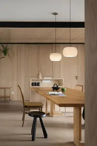 Modern dining room with wooden furniture and minimalist decor.