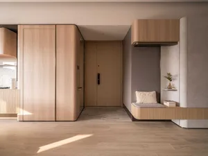 Modern apartment entryway featuring wooden and concrete interior design elements.