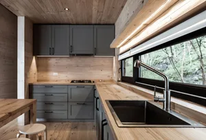 A modern kitchen with wooden countertops and metal sink.