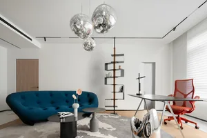 Modern living room featuring sleek metal furniture and glass accents