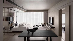 Modern residential living space with concrete, wood finishes, and contemporary furniture.
