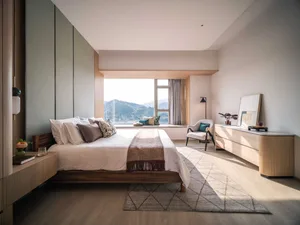 A modern, minimalist bedroom featuring a wooden bed with a cozy, casual vibe.