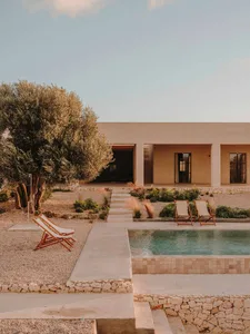 A modern residential exterior with concrete and stone materials.