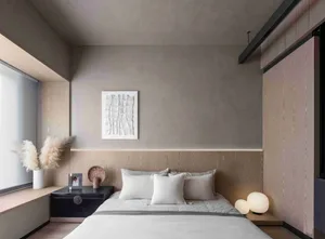 A minimalist bedroom with a wooden headboard, white bedding, and a window with white blinds.