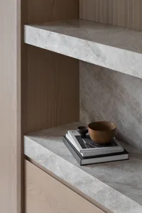 A minimalist interior design featuring marble and wooden elements.