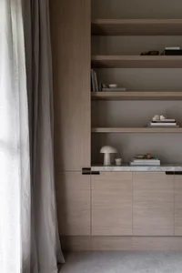A modern bookshelf with wooden cabinets and wooden shelves.