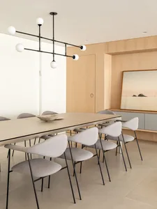 A modern dining room featuring wooden furniture and a minimalist design.