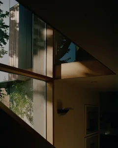 A modern interior featuring large glass panels.