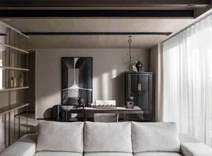 A modern living room featuring a white sofa, a wooden dining table, and a large abstract painting on the wall.