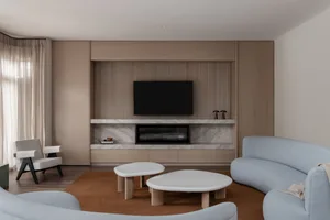 Modern living room with wooden walls, marble floor, and minimalist furniture.