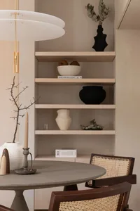 Minimalist dining room with stone table and wooden chairs