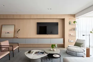 Modern minimalist living room featuring wood, marble, and textile finishes.