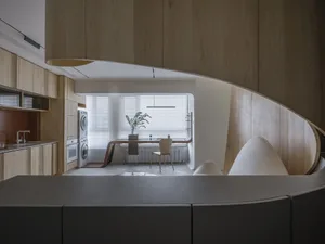 Modern kitchen with wooden finishes and minimalist design.