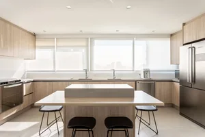 Modern residential kitchen with wooden cabinets and a central island.
