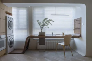 Modern workspace featuring a wooden desk and blinds
