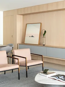 A modern living room featuring minimalist design, wood furniture, and gray elements.
